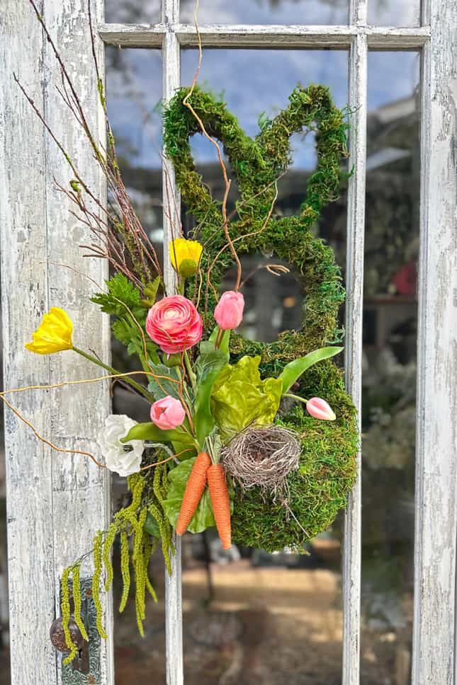 Adding a bird's nest, carrots, and more flowers to my spring easter wreath. 