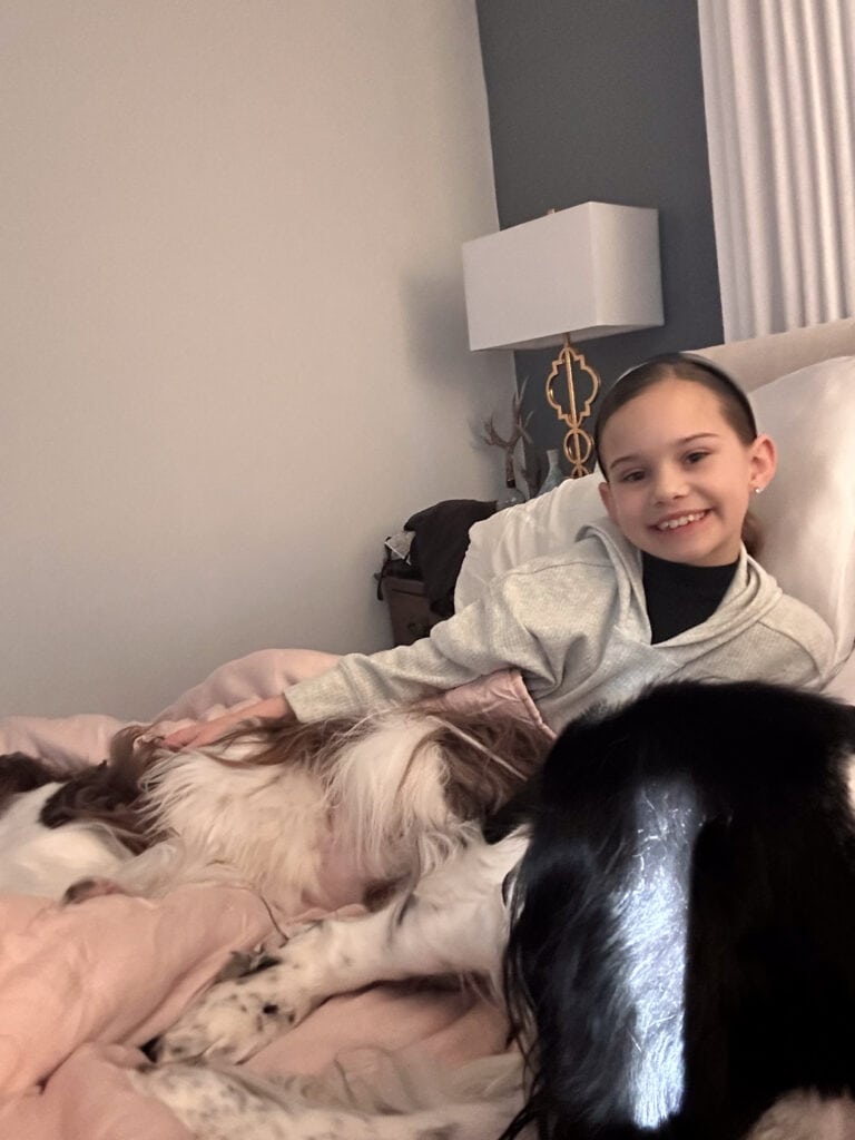 Maddie in bed with the dogs