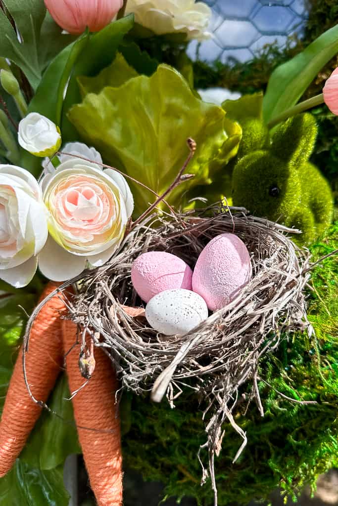 A bird's nest, eggs, and a small moss bunny were added to my Dollar Tree Easter wreath.