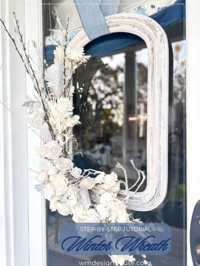 A wooden flower winter wreath is hanging on the door. I made this wreath using an old picture frame.