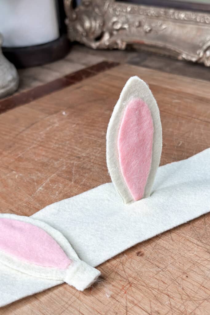 Showing the rabbit ear in the slit in preparing to make napkin rings.