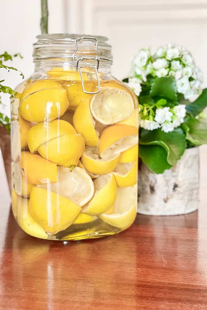 Lemon rinds in vinegar to make a DIY lemon cleaner.