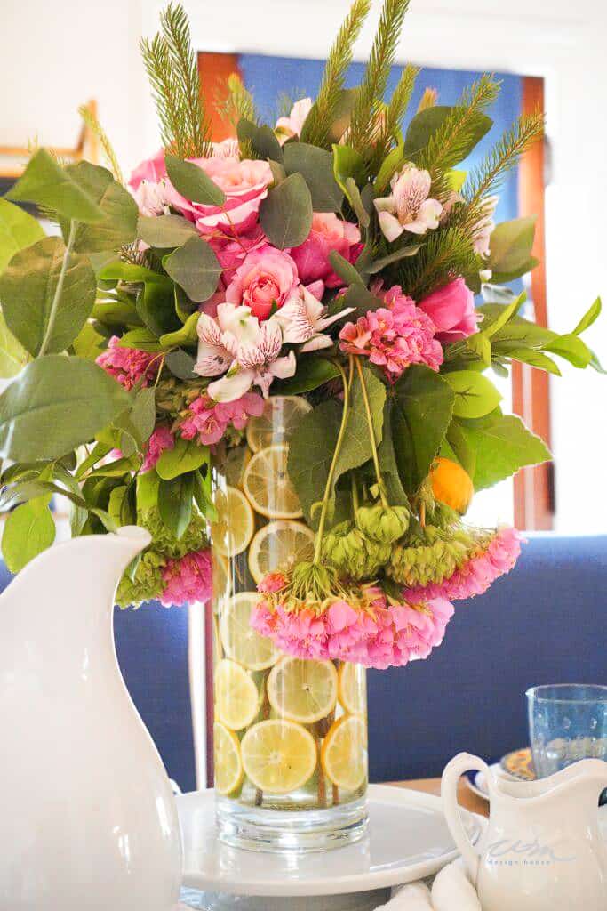 flower arrangement in a vase with sliced lemons
