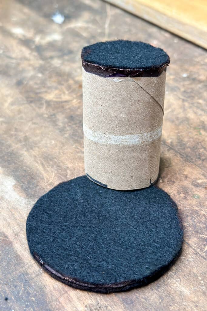 showing the top of the tp roll is covered with felt, and the base is glue, so we are almost ready to assemble our top hat to make a DIY rabbit ear with a top hat napkin ring.