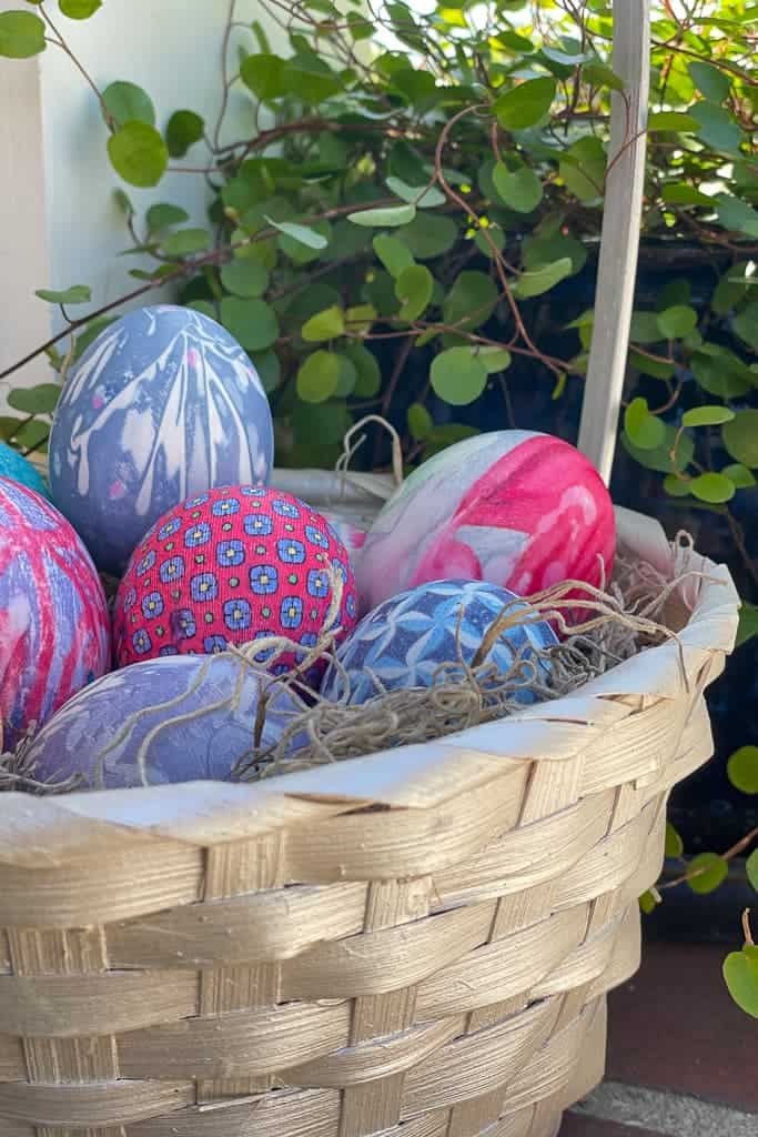Tie- dyed Easter eggs in an Easter basket.