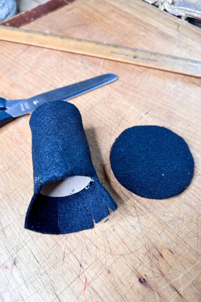 Wrapping the top of the hat with black felt for a DIY Easter napkin ring