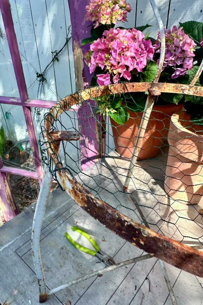 I am adding a chicken wire basket to a chair to make a vintage chair planter.