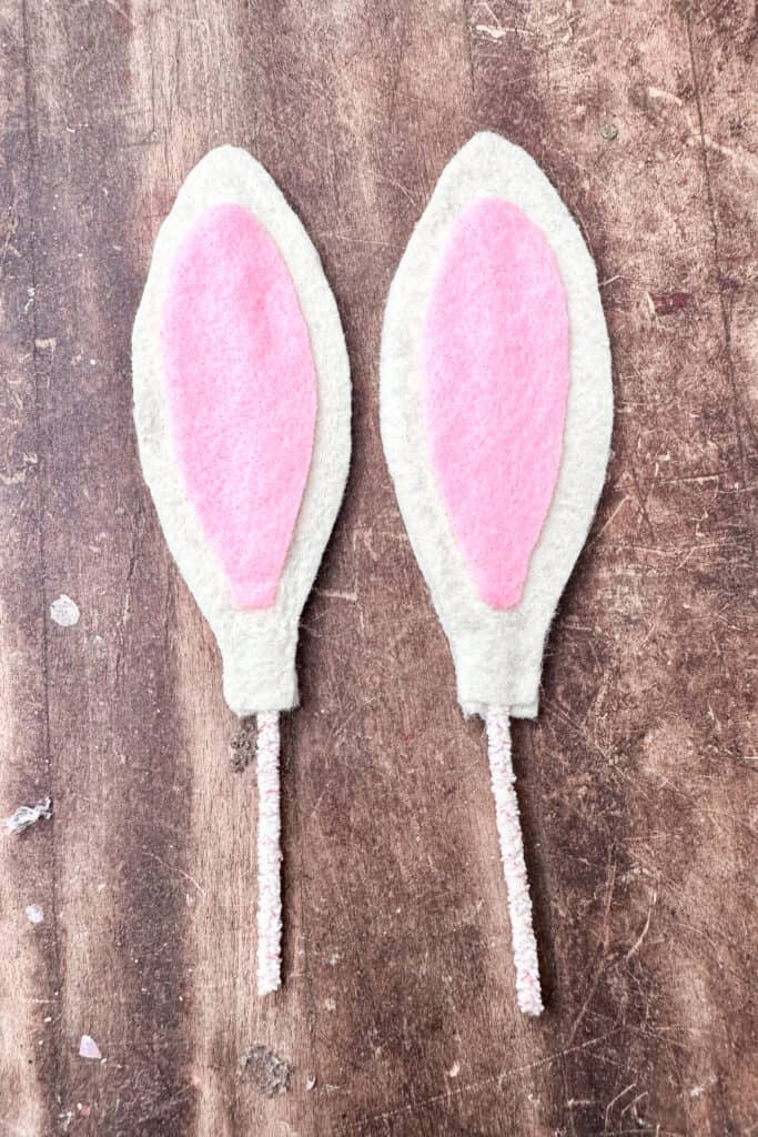 pink felt inside of the white bunny ears preparing to make easter napkin rings