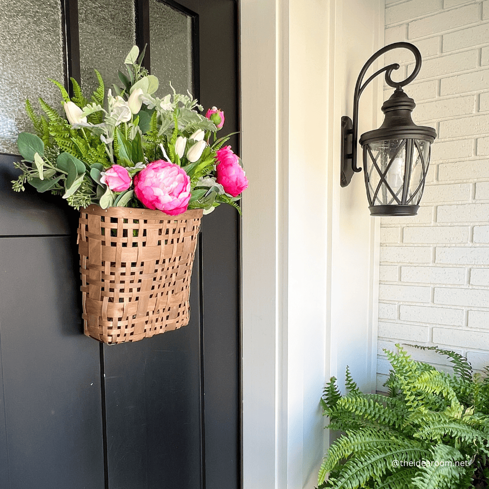 The basket on front door with flowers
