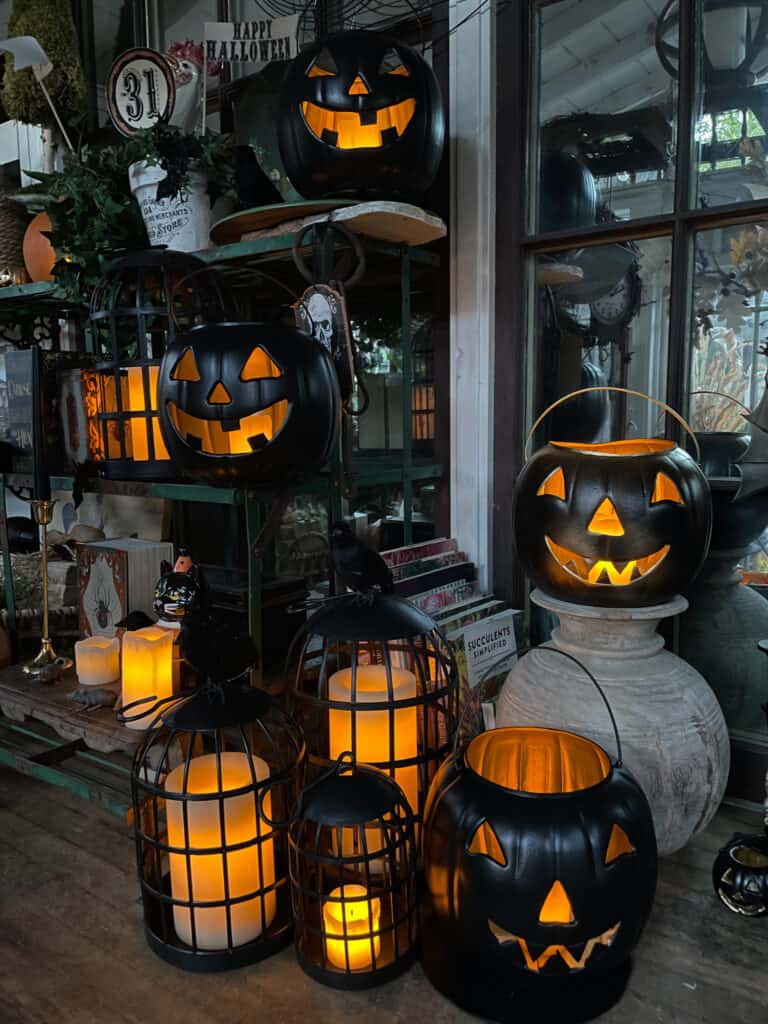 DIY black jack-o-lanterns with lights and vintage Halloween decor in the She Shed