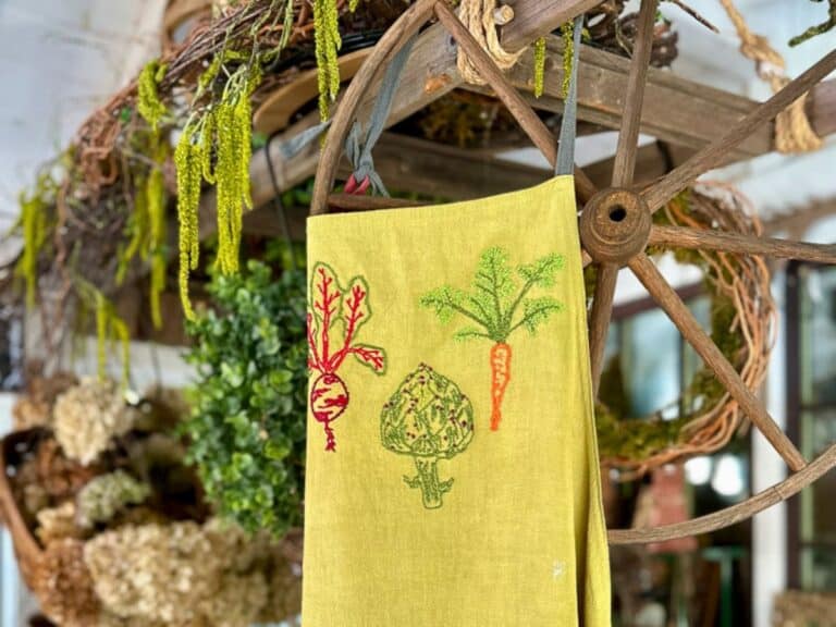 DIY embroidery idea with vegetables embroidered on a garden apron.