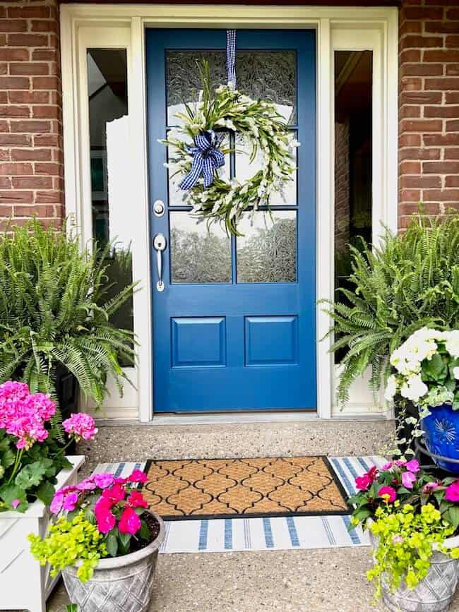 Kim front porch with blue door.