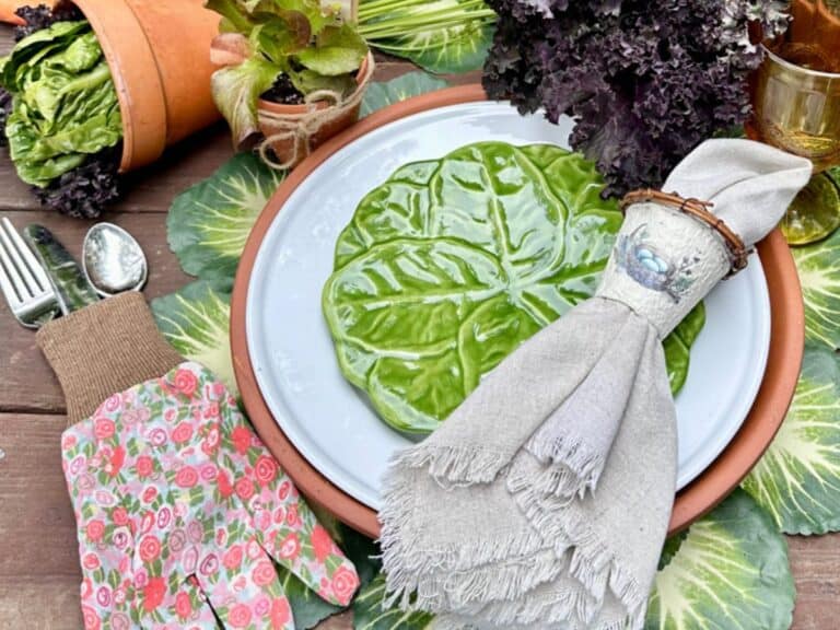 A DIY napkin ring styled on a table with plates of green, white and terra cotta.