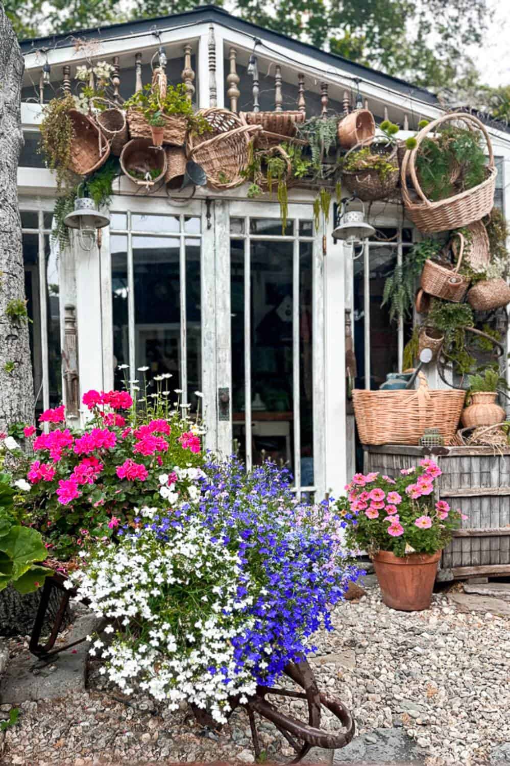 She Shed decorated for summer with a basket decor arch