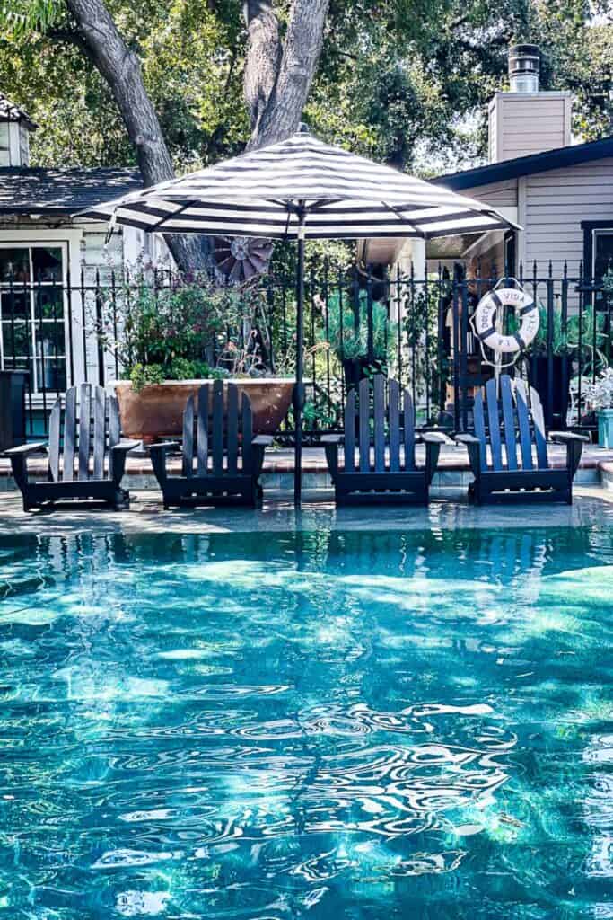 California backyard living with a swimming pool that has a baja step with four chairs.California Backyard Living.