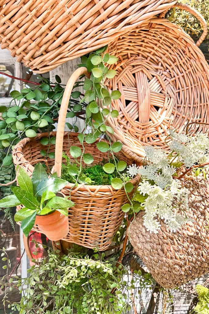 Baskets with greenery hanging around the shed doors. 