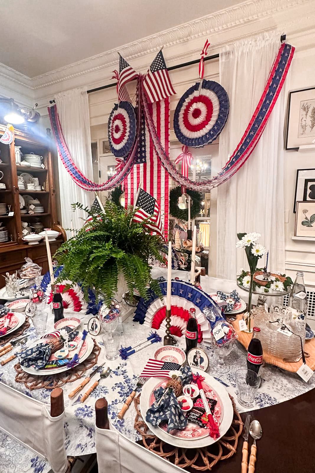 American flag paper fans hanging on the wall for a patriotic dinner party 