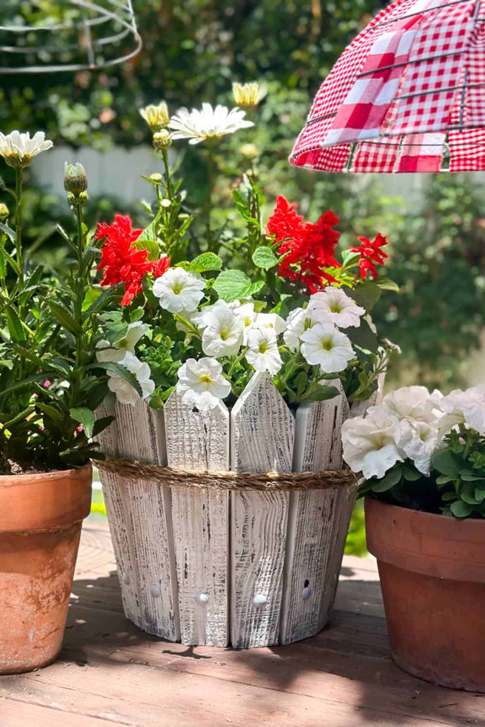 Petunias planted in a DIY picket fence flower pot.