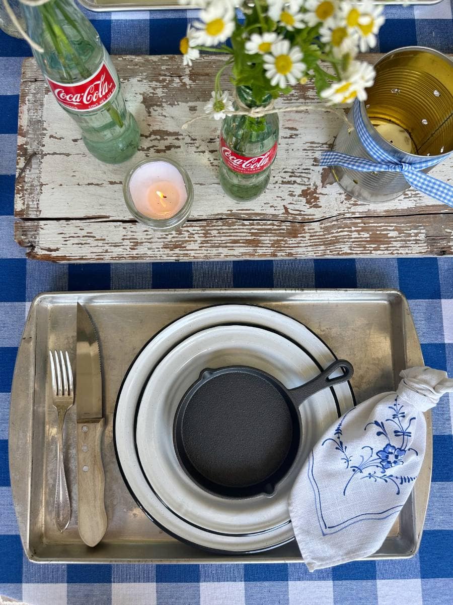 Place Setting in neutral colors with coke bottle centerpiece for a smoke it summer tablescape. 