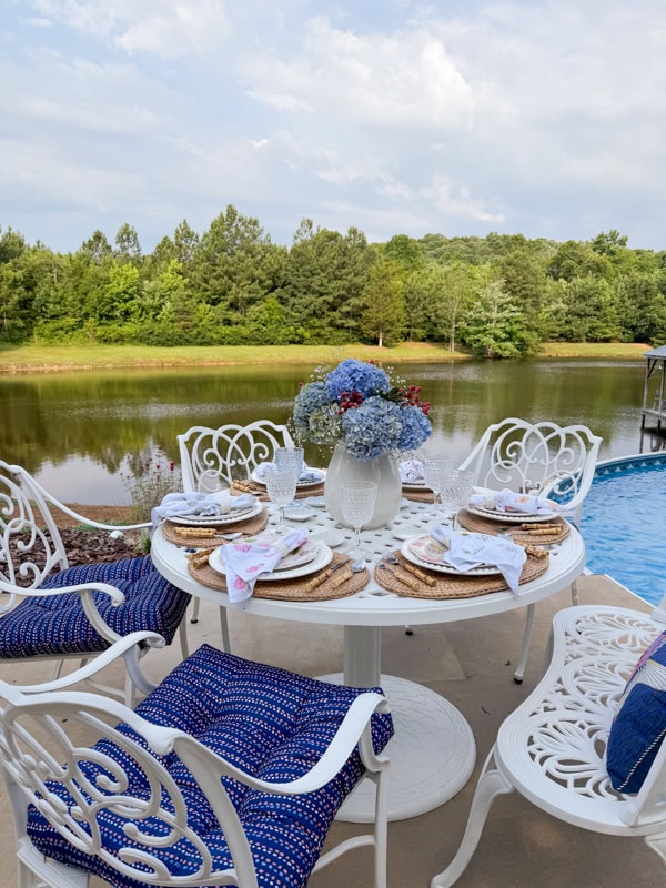 Poolside dining with blue hydrangeas 