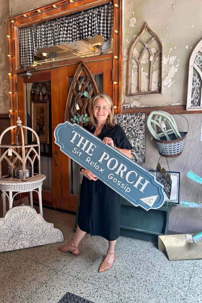 Wendy holding a porch sign