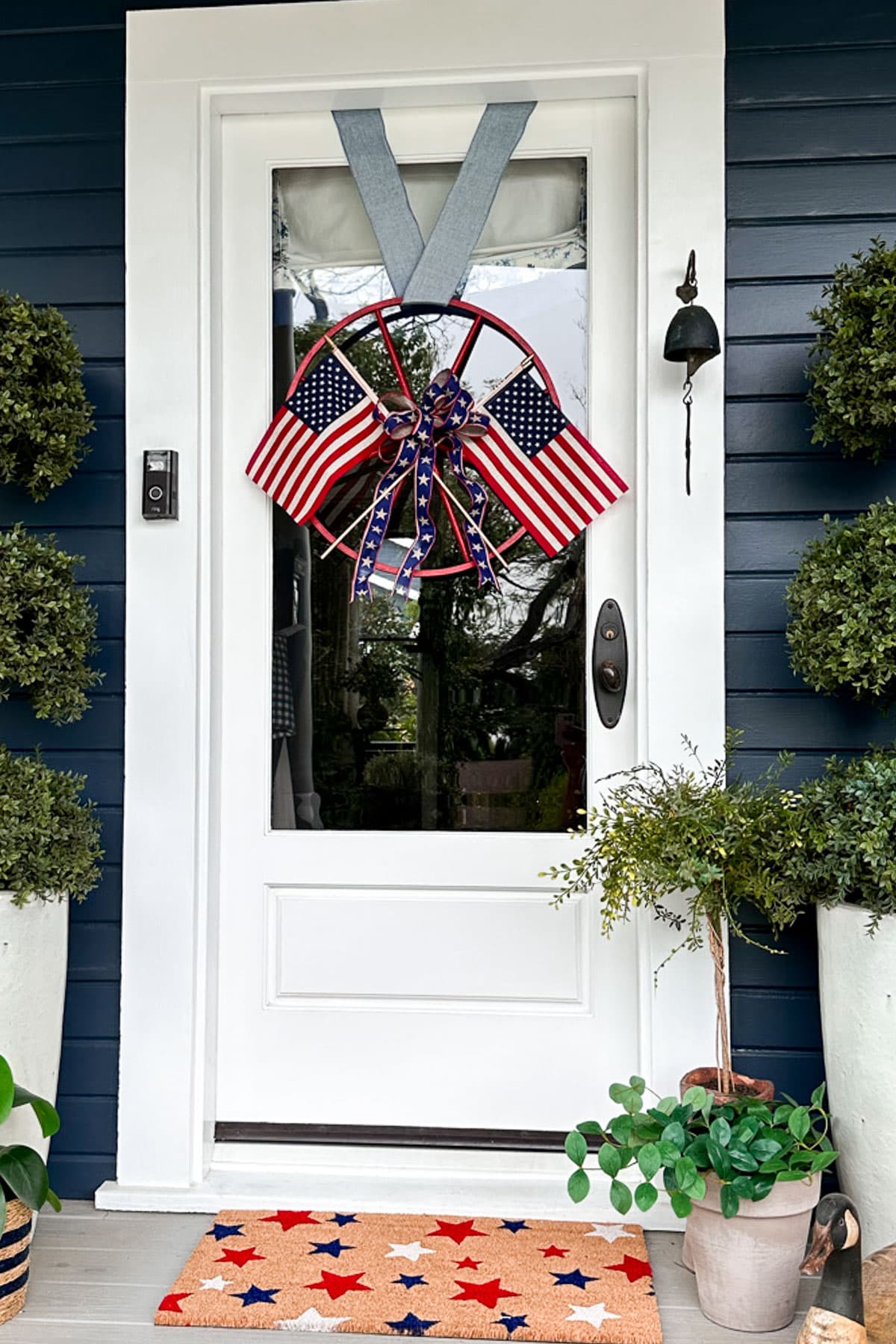The front door was decorated for the Fourth of July with a flag wreath and a doormat with stars. 