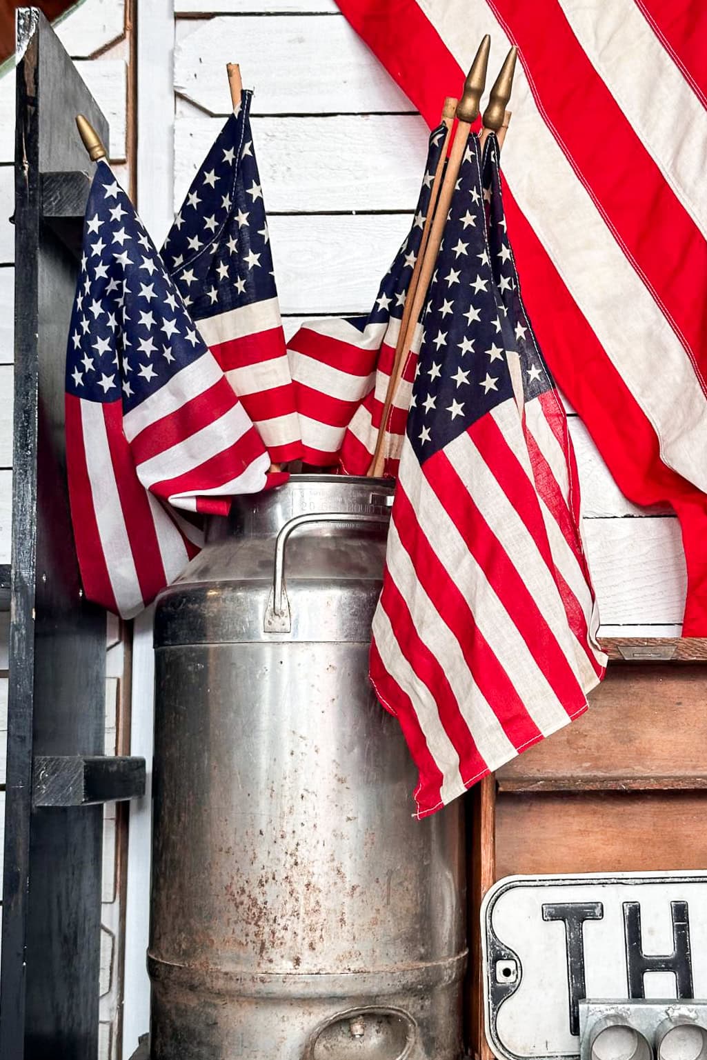 Decorating with American Flags arranged in a vintage milk can