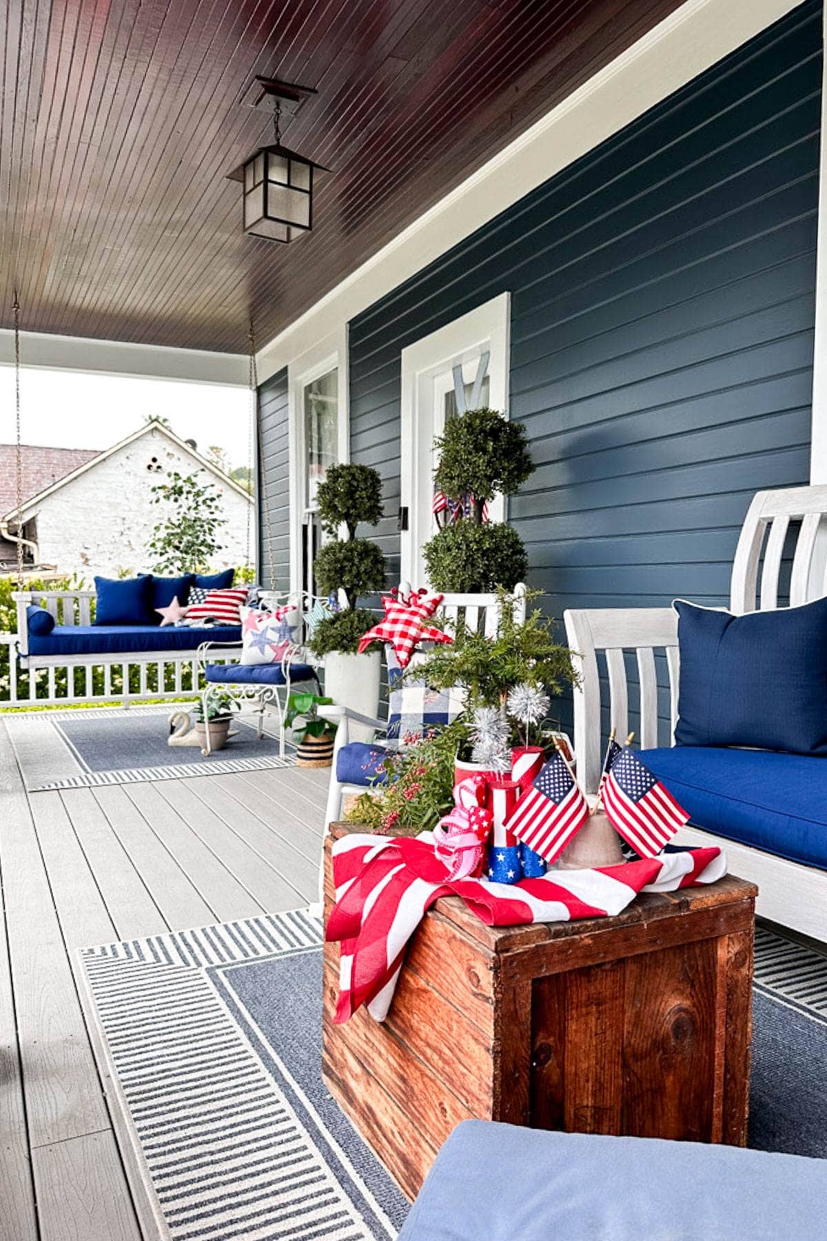 DIY throw pillow styled on the front porch decorated for the Fourth of July 