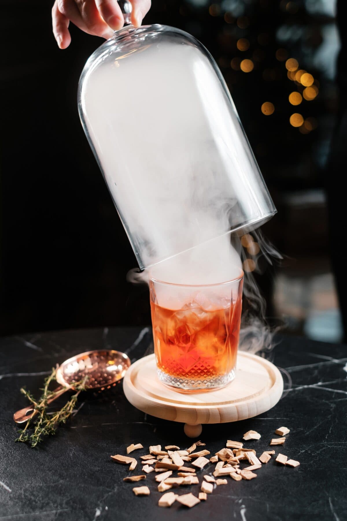 Smoking a cocktail with a smoking dome. 