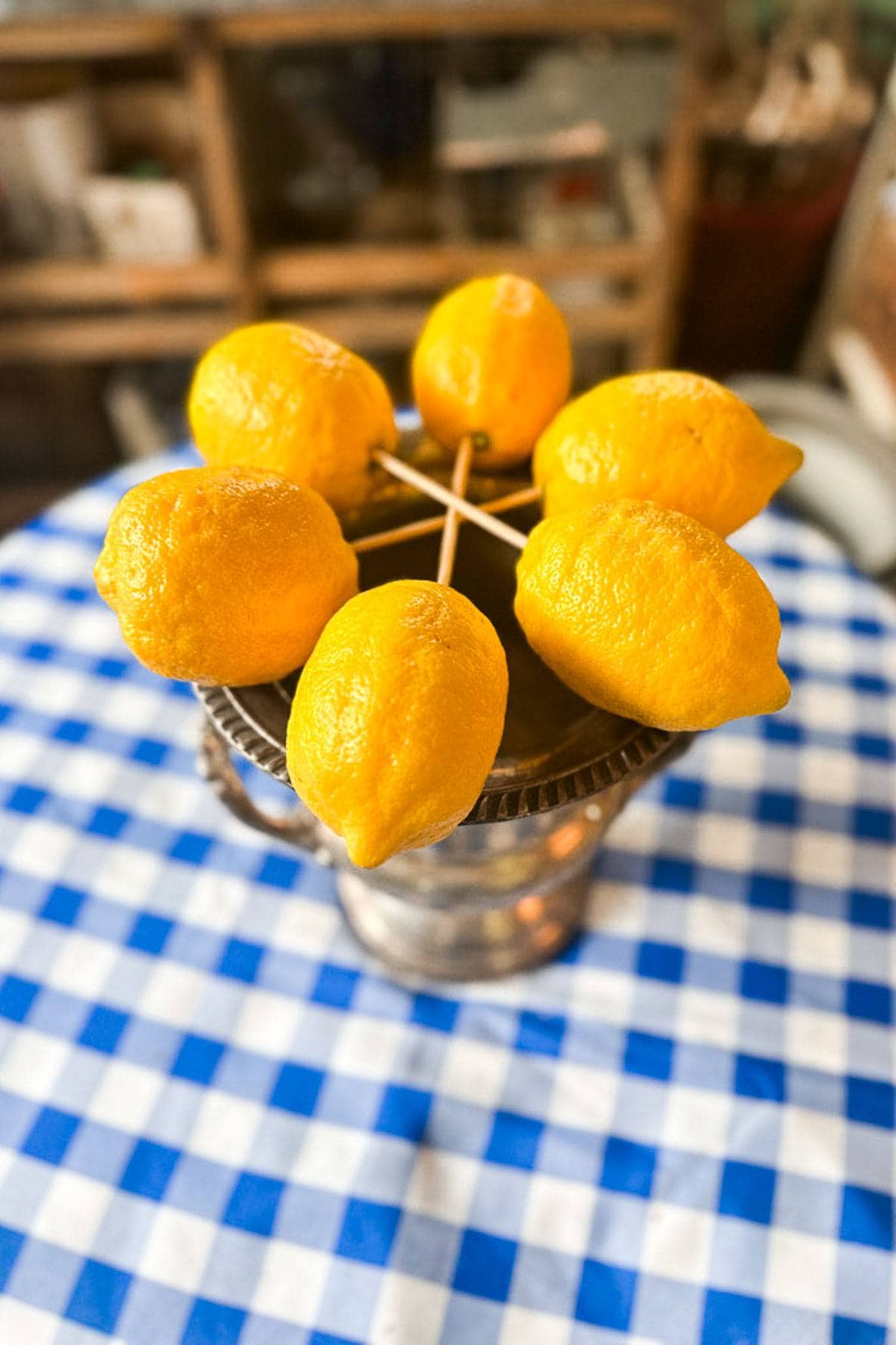 6  lemons put together with skewers to form the first layer of our lemon tree ceneterpiece. 