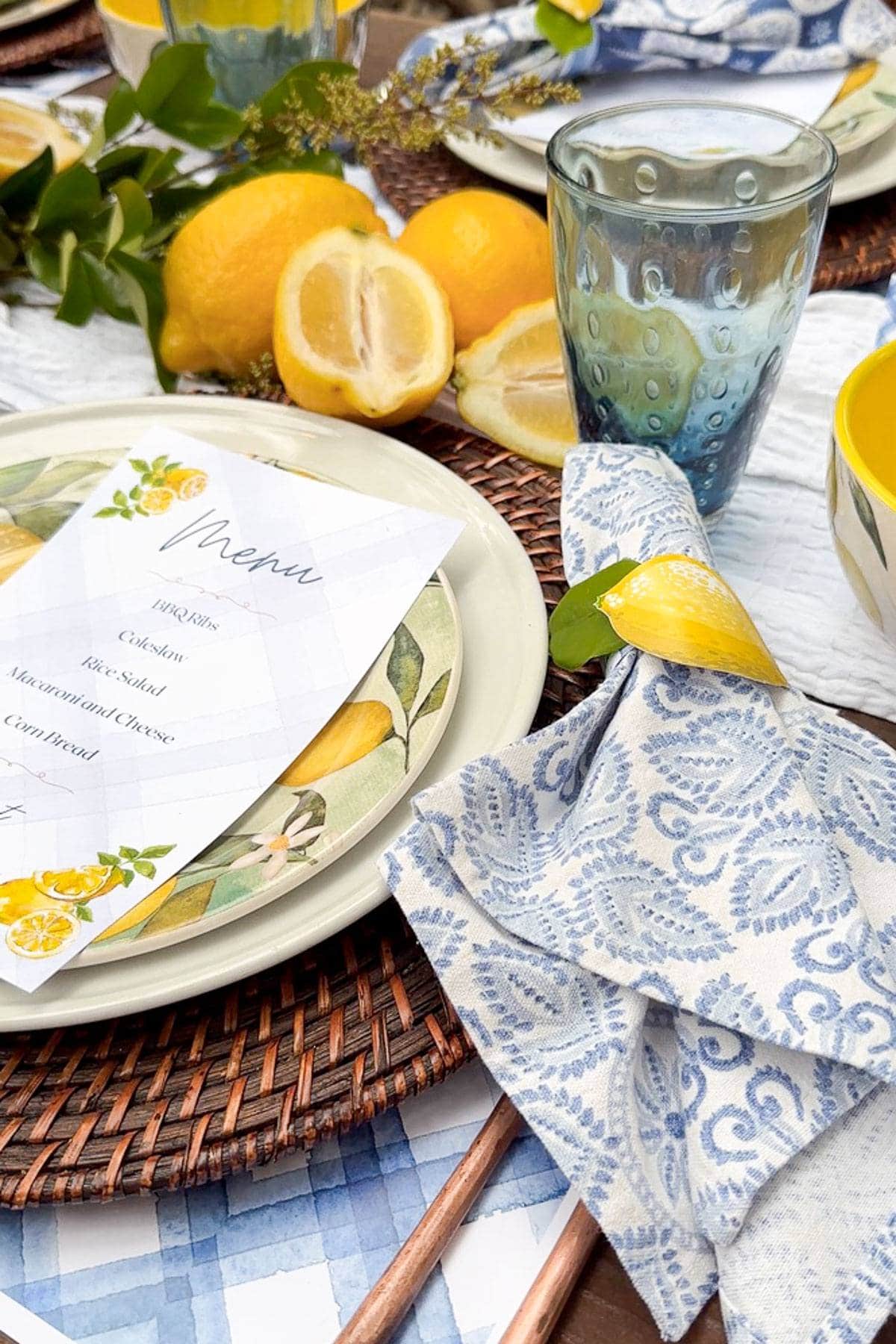 place setting for a yellow and blue summer tablescape with lemons