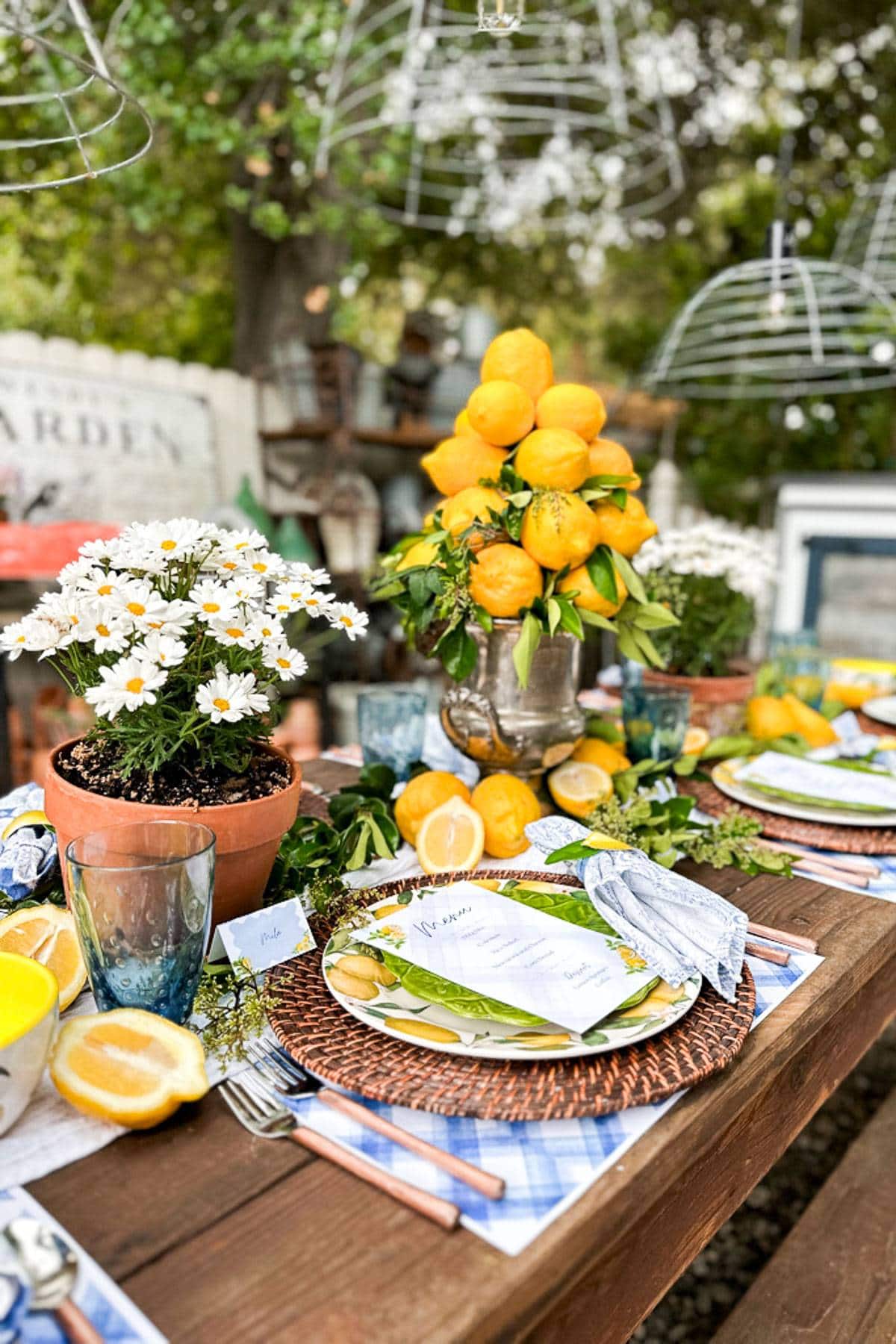 A lemon tablescape with a lemon centerpiece made with fresh Meyer lemons. 