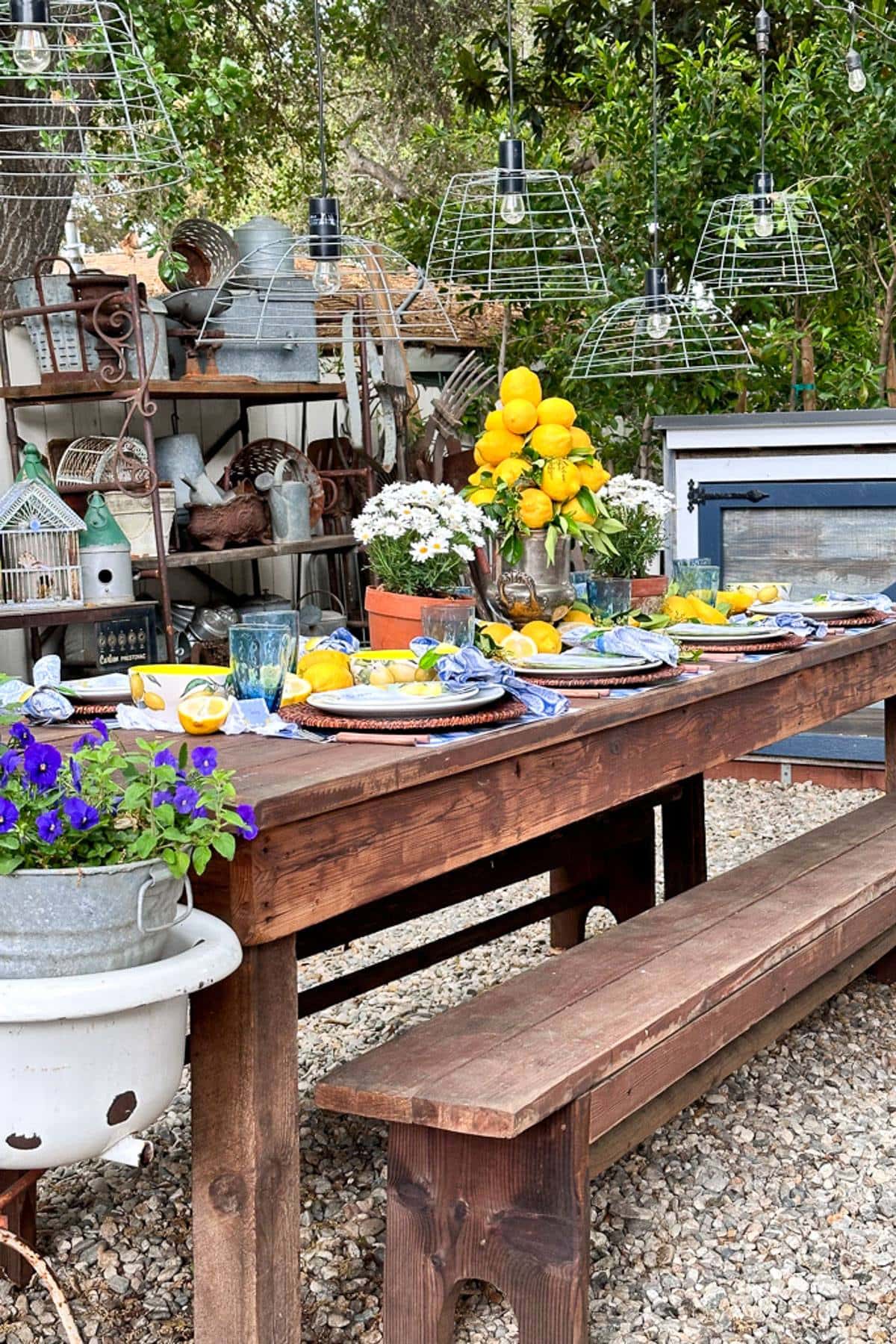 Summer tablescape with lemons and fresh flowers set outside in the garden