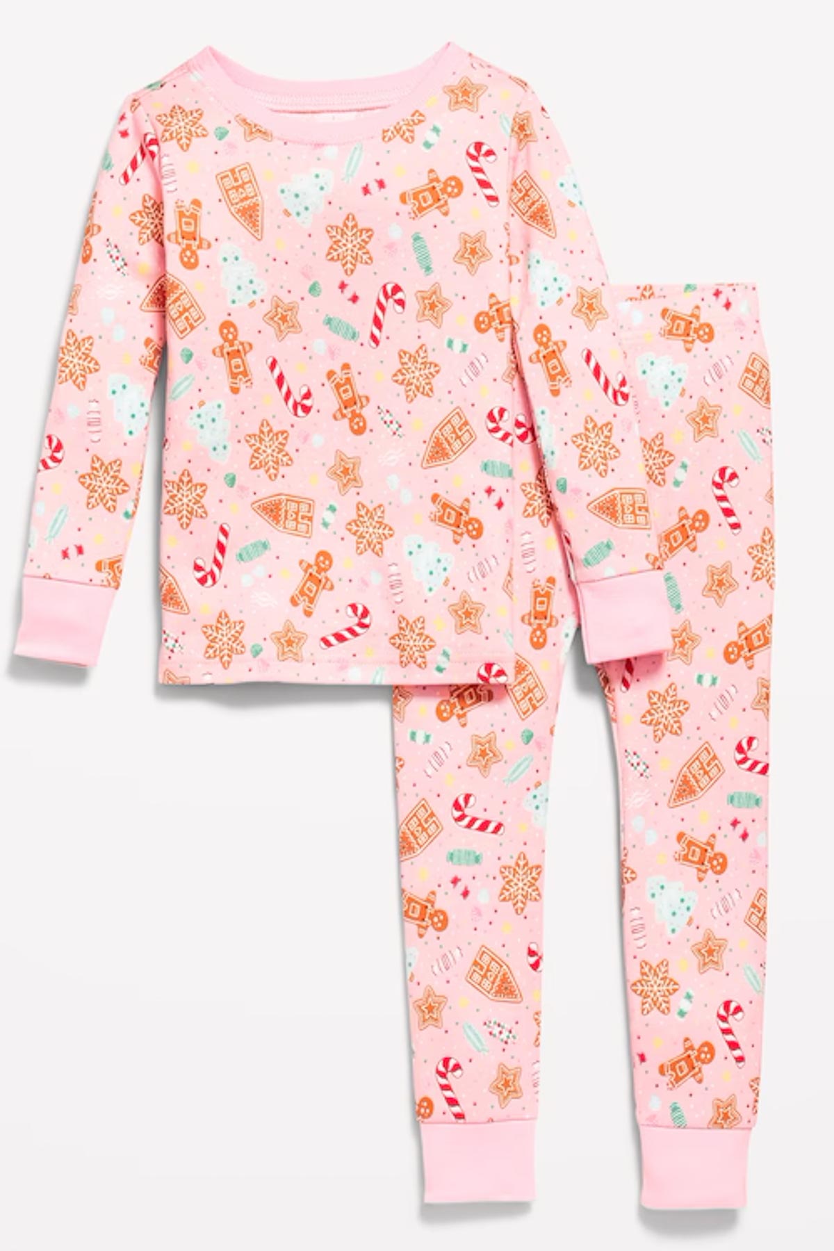 Children's pink pajama set featuring festive gingerbread cookies, candy canes, snowflakes, and Christmas decorations. The set includes a long-sleeve top and matching pants with ribbed cuffs.