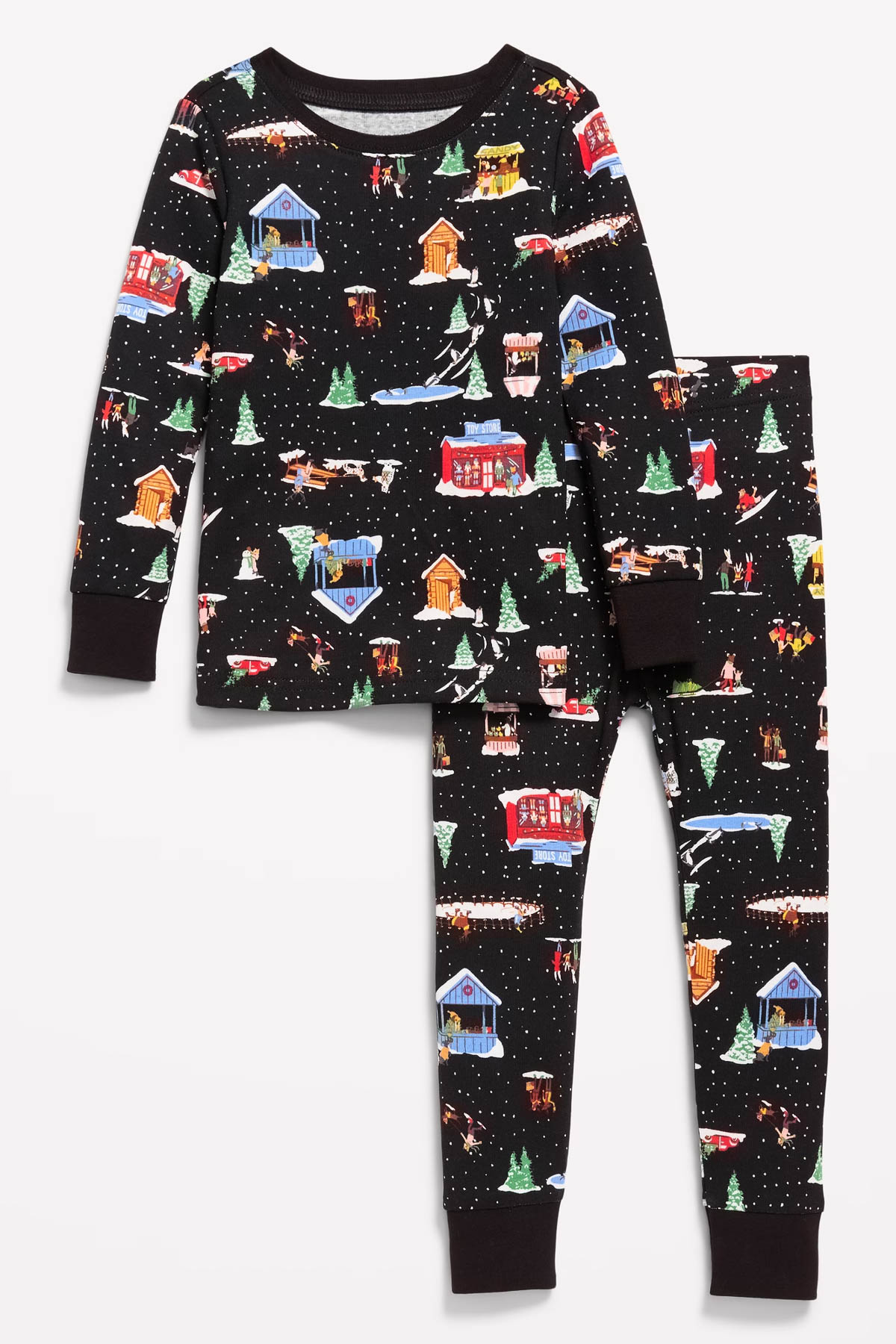 A set of children's pajamas with a festive winter theme on a black background, perfect for a Christmas Pajama Party with the grandkids. The design features colorful illustrations of cabins, snow-covered trees, and small figures playing in the snow. The set includes a long-sleeved top and matching pants.