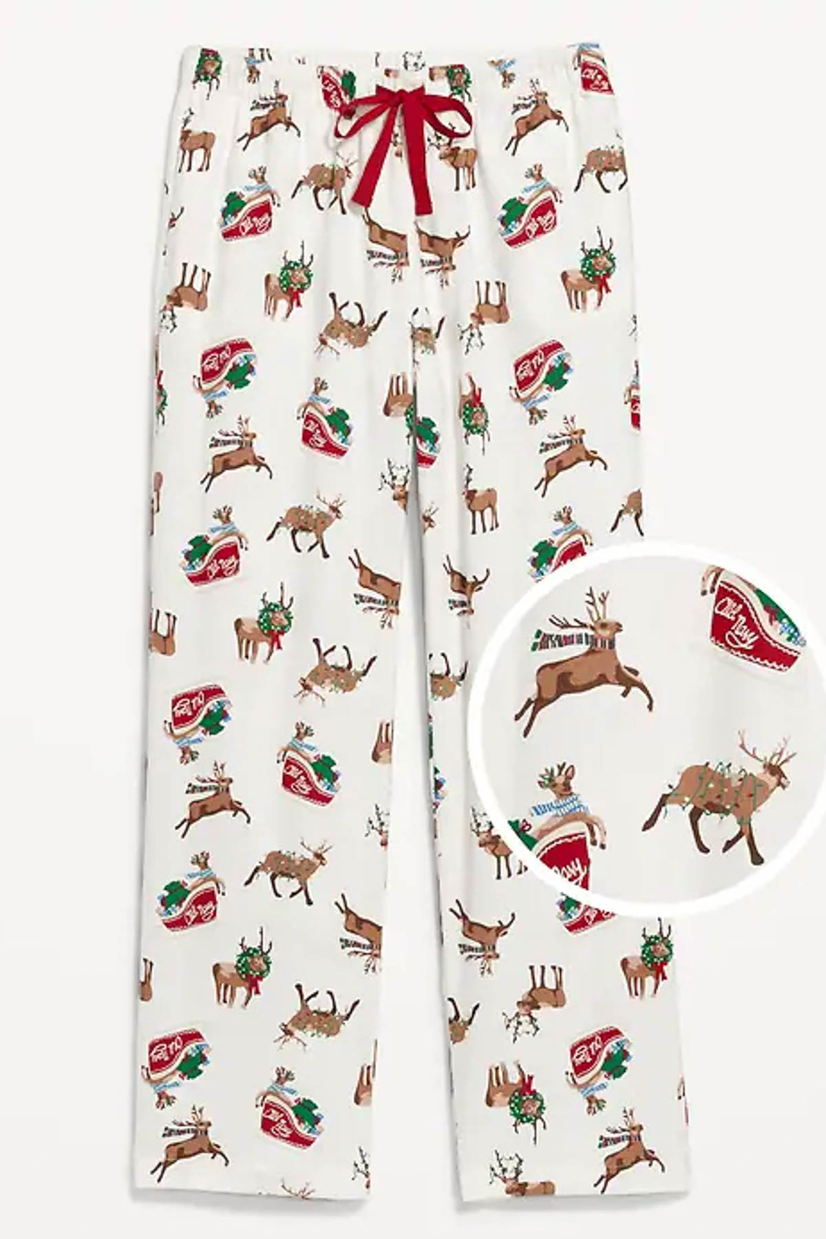 White pajama pants with a festive print featuring reindeer, holly leaves, and red oval shapes with "7up" logos—perfect for a Christmas Pajama Party with the grandkids. A red drawstring adds a pop of color at the waistband. A circular close-up highlights the pattern detail.