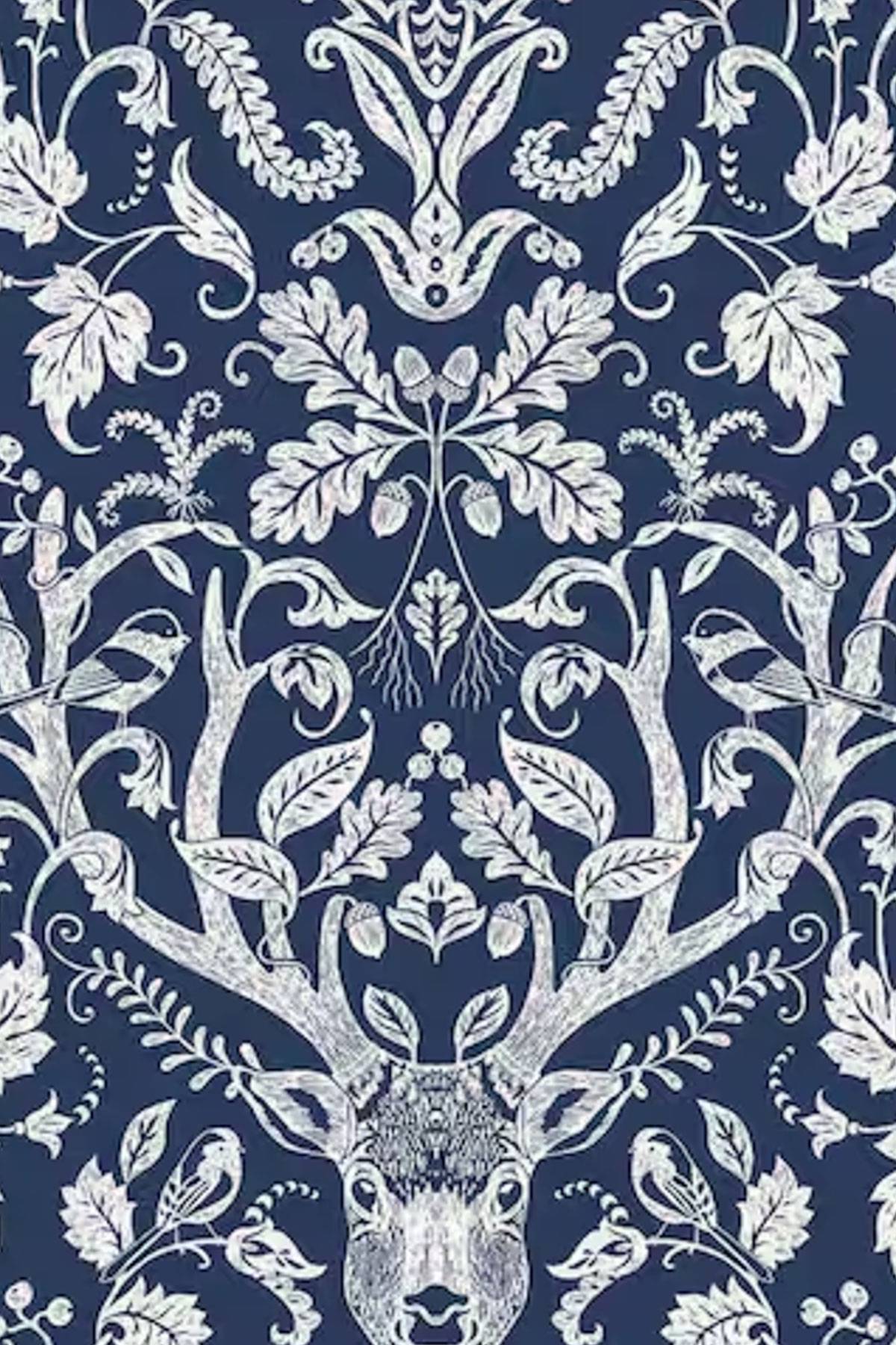 Intricate white floral and leafy patterns form a symmetrical design on a dark blue background. At the center is a detailed depiction of a deer's head with large antlers, surrounded by foliage and birds, creating a nature-inspired motif.