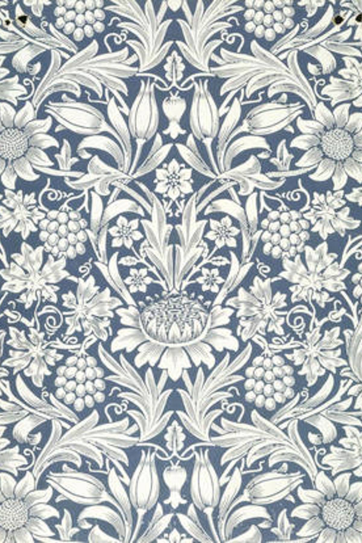 Ornate floral wallpaper design with intricately detailed white flowers, leaves, and vines on a blue background. The symmetrical pattern includes tulips, daisies, and grape clusters, creating a vintage and elegant appearance.