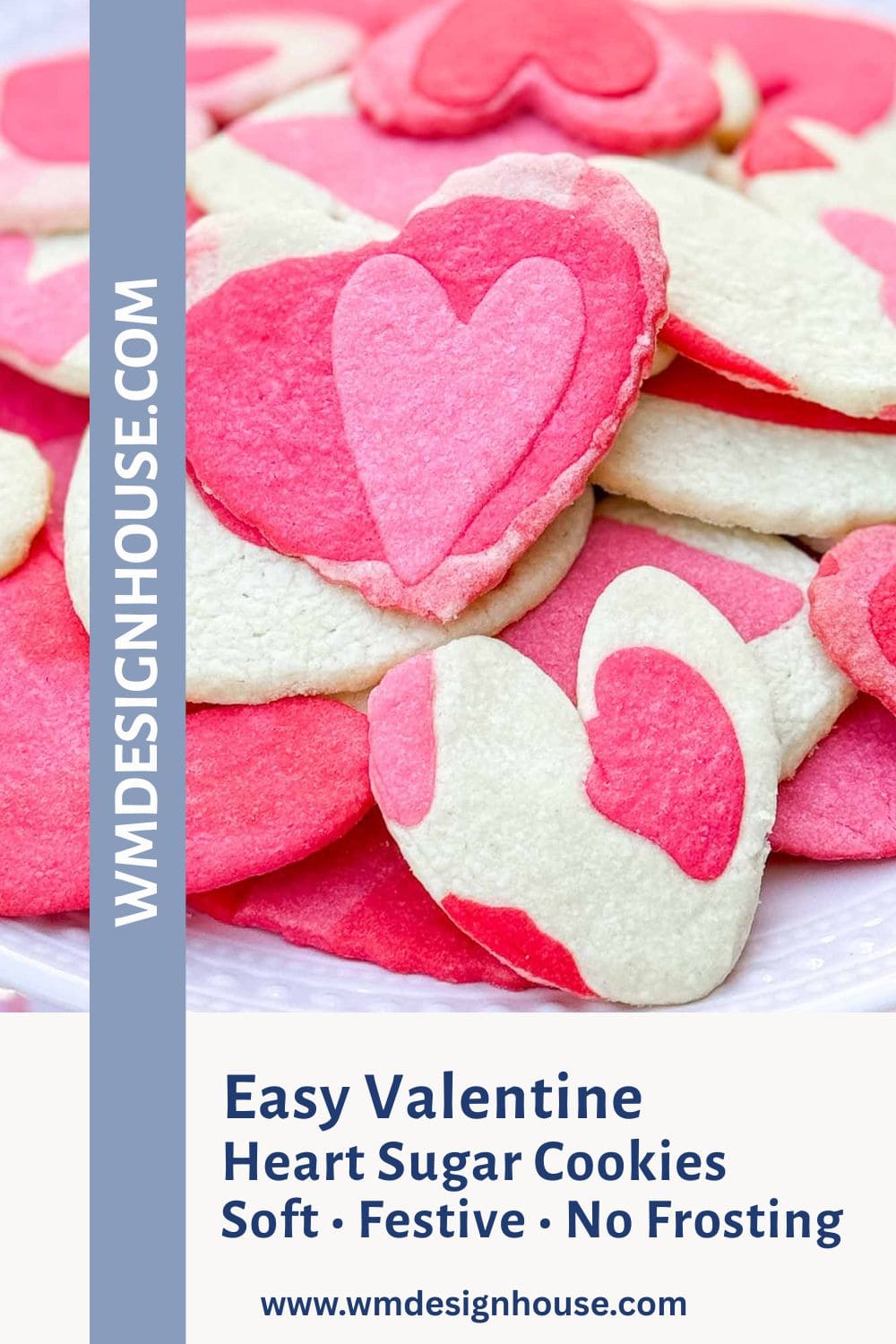 A plate of heart-shaped sugar cookies in pink, white, and red, some with heart patterns. Text reads, "Easy Heart Sugar Cookies—Soft • Festive • No Frosting," with the website "wmdesignhouse.com" on the side.