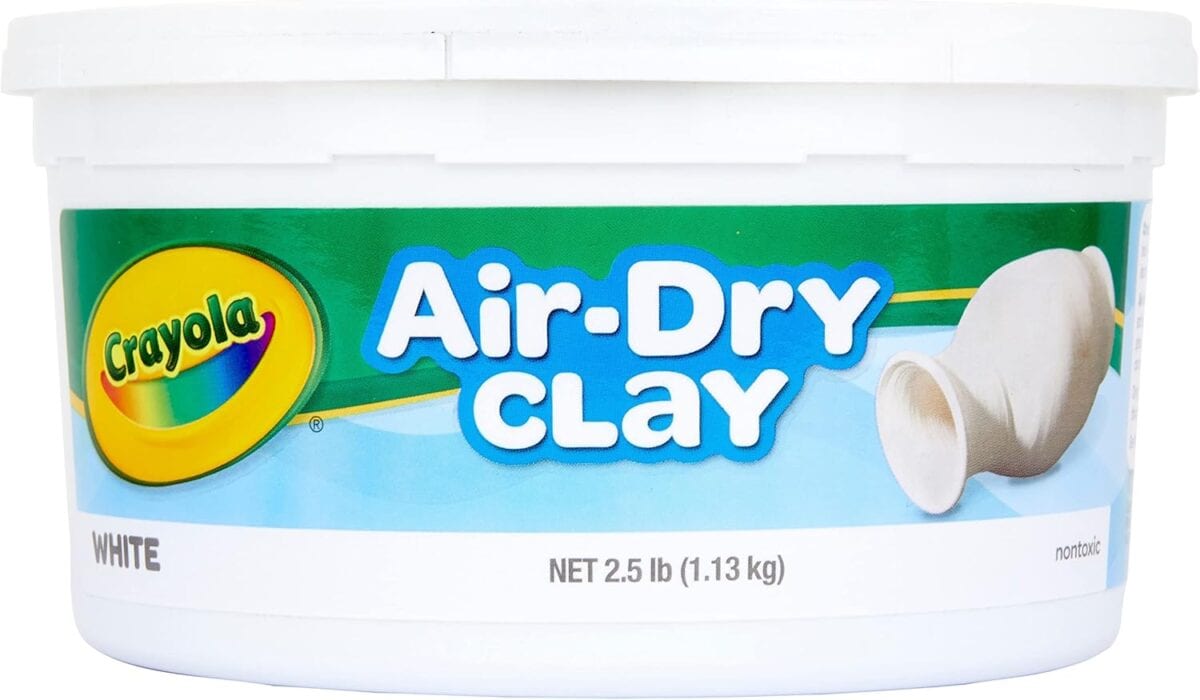 A white container of Crayola Air-Dry Clay, labeled “WHITE,” displays a clay pot and the Crayola logo. Perfect for crafting projects like Lace Hearts, it weighs 2.5 lbs (1.13 kg).