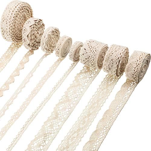 Eight rolls of cream-colored crochet lace ribbon, including charming Lace Hearts patterns, are unspooled and displayed in parallel lines on a white background.