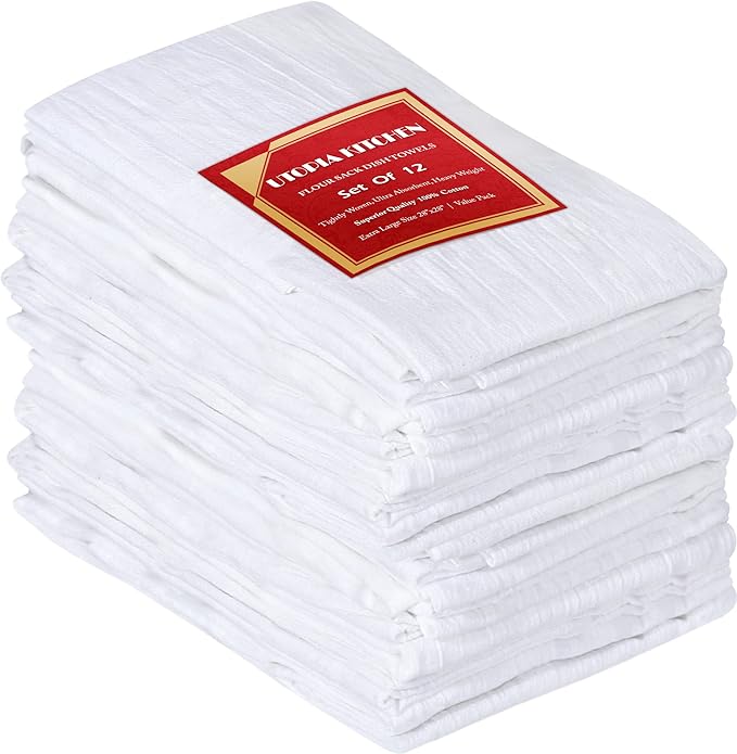 A stack of twelve folded white kitchen towels, perfect for vegetable block printing, with a red and gold label on top that reads "Utopia Kitchen, Set of 12.