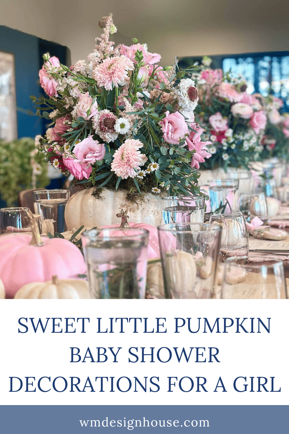 Table set for a baby shower with pink and white flowers arranged in white pumpkins, pink pumpkins, glassware, and place settings. The sign reads, “Sweet little pumpkin baby shower decorations for a girl,” perfectly tying together this charming theme.