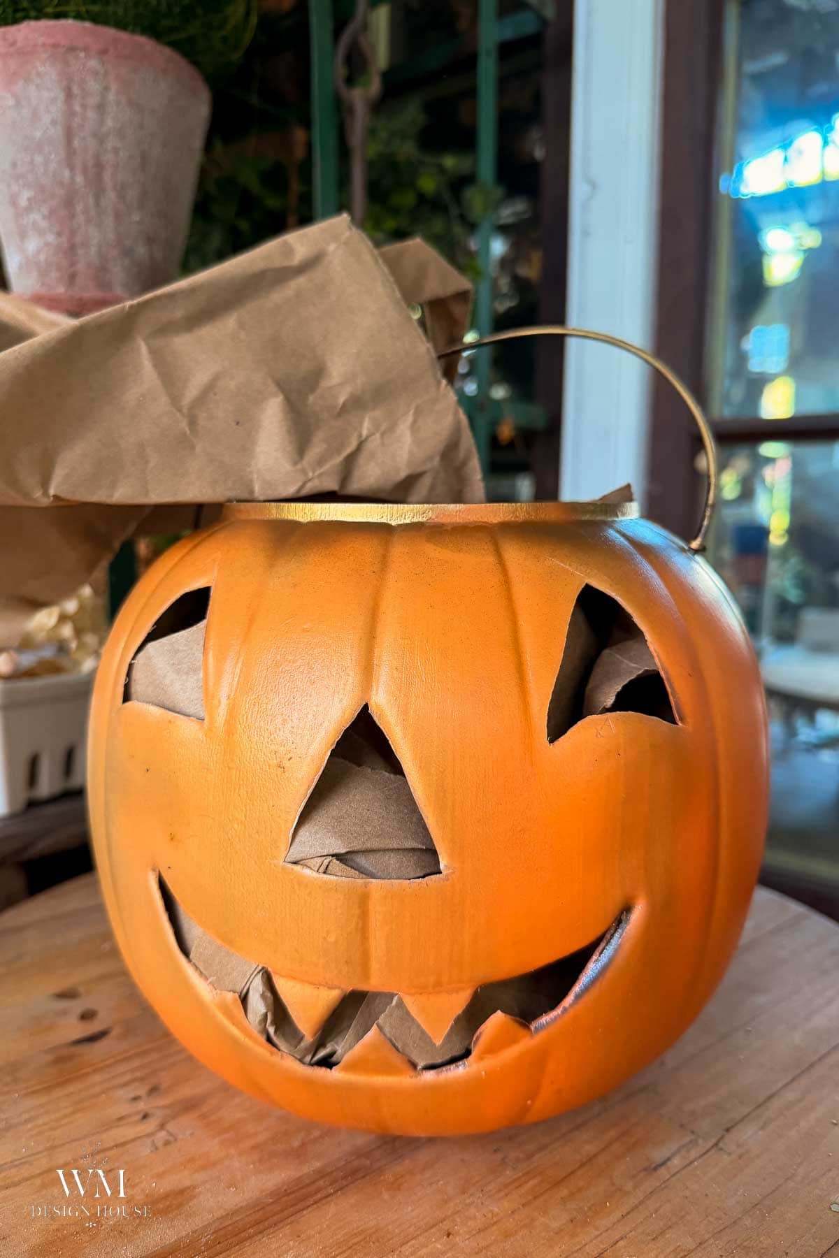 Black jack o' lantern lanterns lit with battery candles glowing gold at night in the Sheshed. 
