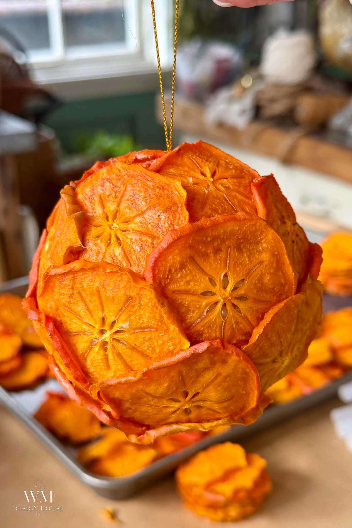 A round ornament handmade from overlapping, dried persimmon slices.