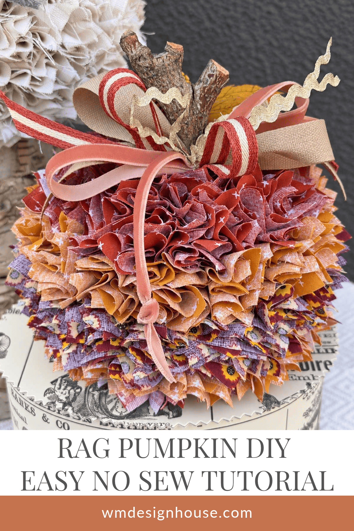 A fabric no sew pumpkin made with 2" squares of scrap favric. A natural twig used for the stem and decorated with striped ribbon and beige rick rack.